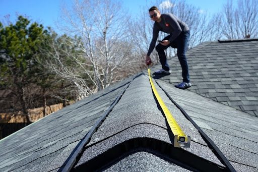 A professional roof inspector at work. A professional roof inspector at work.